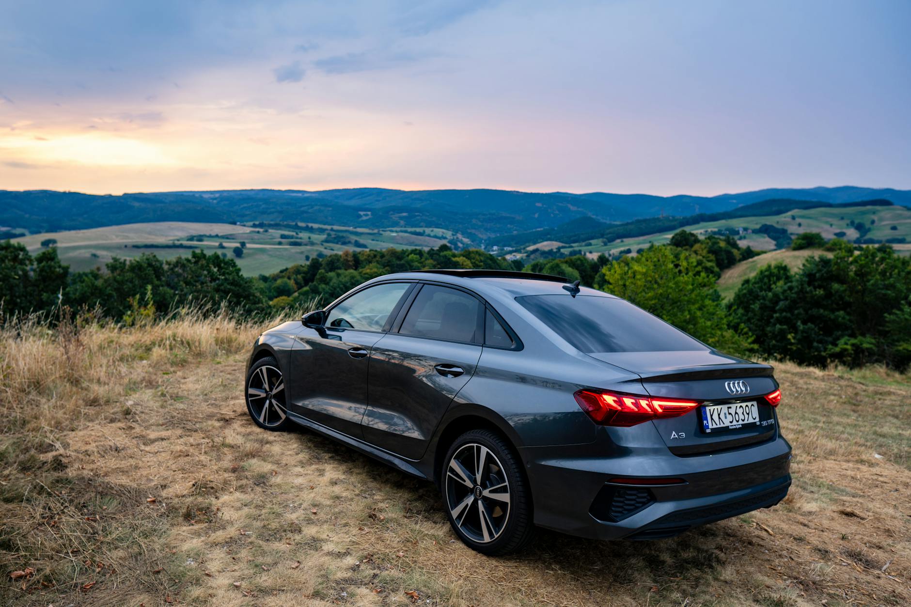 the back of a black audi parked on a hillside