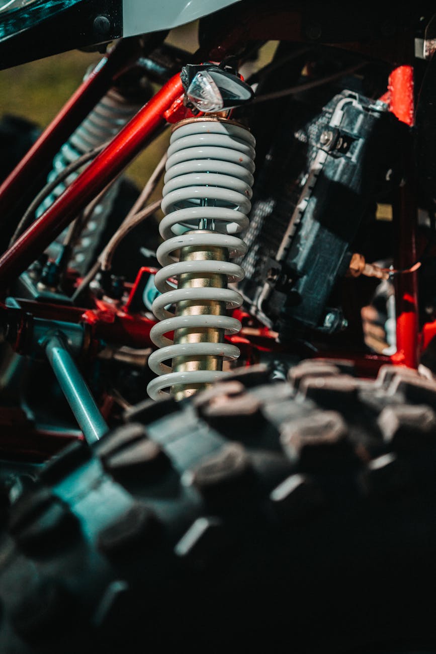 close up of the coil spring and shock absorber on an atv